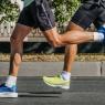 legs two male runners running city marathon race, athletes jogging on asphalt road, summer sports games